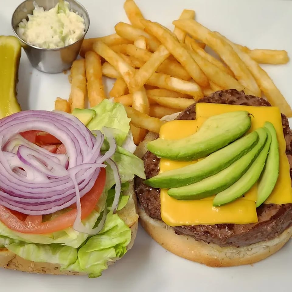 Shore Road Diner's open-faced cheeseburger with avocado, lettuce, tomato, onion, fries, coleslaw, and a pickle.